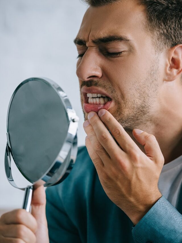 young-man-with-toothache-looking-at-mirror-2024-11-18-18-53-44-utc